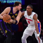 Dec 30, 2025; Los Angeles, California, USA; Los Angeles Lakers guard Luka Doncic (77) controls the ball against Detroit Pistons guard Ausar Thompson (9) during the first half at Crypto.com Arena. Mandatory Credit: Gary A. Vasquez-Imagn Images