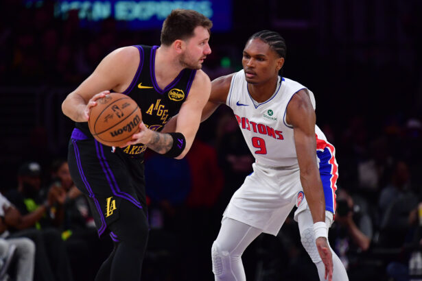 Dec 30, 2025; Los Angeles, California, USA; Los Angeles Lakers guard Luka Doncic (77) controls the ball against Detroit Pistons guard Ausar Thompson (9) during the first half at Crypto.com Arena. Mandatory Credit: Gary A. Vasquez-Imagn Images