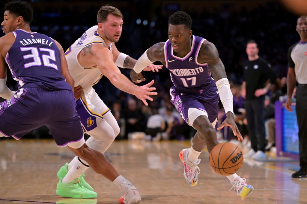 Dec 28, 2025; Los Angeles, California, USA; Sacramento Kings guard Dennis Schroder (17) drives past Los Angeles Lakers guard Luka Doncic (77) in the first half at Crypto.com Arena. Mandatory Credit: Jayne Kamin-Oncea-Imagn Images