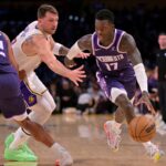 Dec 28, 2025; Los Angeles, California, USA; Sacramento Kings guard Dennis Schroder (17) drives past Los Angeles Lakers guard Luka Doncic (77) in the first half at Crypto.com Arena. Mandatory Credit: Jayne Kamin-Oncea-Imagn Images
