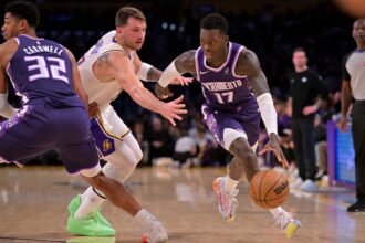 Dec 28, 2025; Los Angeles, California, USA; Sacramento Kings guard Dennis Schroder (17) drives past Los Angeles Lakers guard Luka Doncic (77) in the first half at Crypto.com Arena. Mandatory Credit: Jayne Kamin-Oncea-Imagn Images