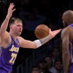 Dec 10, 2025; Los Angeles, California, USA; Los Angeles Lakers guard Luka Doncic (77) and forward Lebron James (23) react after a foul call during the second half against the San Antonio Spurs at Crypto.com Arena. Mandatory Credit: Jayne Kamin-Oncea-Imagn Images
