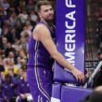 Los Angeles Lakers forward/guard Luka Doncic (77) hugs the stanchion after a foul during the first quarter against the Utah Jazz at Delta Center.