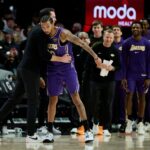 Nov 3, 2025; Portland, Oregon, USA; Los Angeles Lakers guard Nick Smith Jr. (20) celebrates with head coach JJ Redick after a game against the Portland Trail Blazers at Moda Center. Mandatory Credit: Troy Wayrynen-Imagn Images