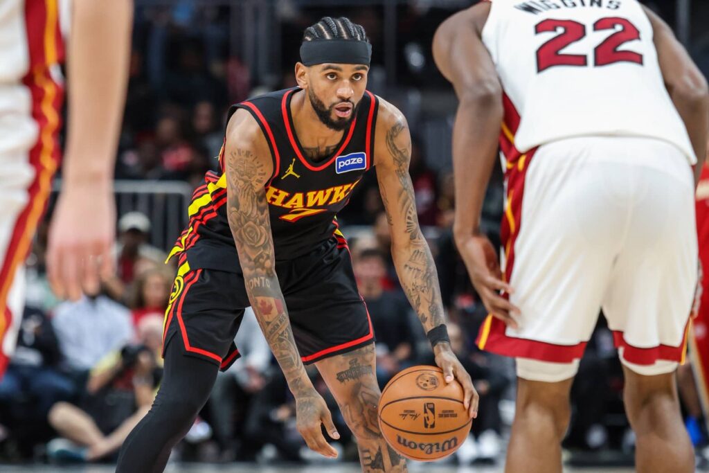 Dec 26, 2025; Atlanta, Georgia, USA; Atlanta Hawks guard Nickeil Alexander-Walker (7) looks for a play against Miami Heat forward Andrew Wiggins (22) during the third quarter at State Farm Arena. Mandatory Credit: Jordan Godfree-Imagn Images