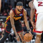 Dec 26, 2025; Atlanta, Georgia, USA; Atlanta Hawks guard Nickeil Alexander-Walker (7) looks for a play against Miami Heat forward Andrew Wiggins (22) during the third quarter at State Farm Arena. Mandatory Credit: Jordan Godfree-Imagn Images