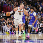 Dec 27, 2025; Orlando, Florida, USA; Denver Nuggets center Nikola Jokic (15) brings the ball up court against Orlando Magic guard Jase Richardson (11) during the second half at Kia Center. Mandatory Credit: Mike Watters-Imagn Images