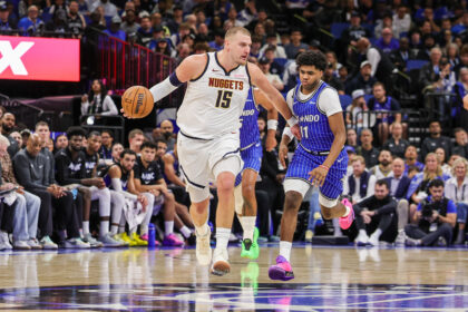 Dec 27, 2025; Orlando, Florida, USA; Denver Nuggets center Nikola Jokic (15) brings the ball up court against Orlando Magic guard Jase Richardson (11) during the second half at Kia Center. Mandatory Credit: Mike Watters-Imagn Images