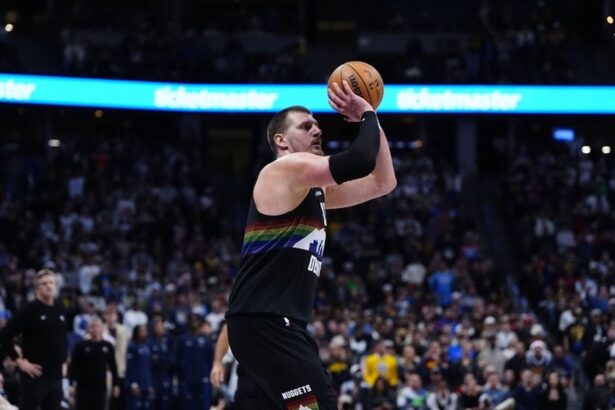 Dec 25, 2025; Denver, Colorado, USA; Denver Nuggets center Nikola Jokic (15) lines up a successful three point basket in overtime against the Minnesota Timberwolves at Ball Arena. Mandatory Credit: Ron Chenoy-Imagn Images