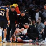 Dec 29, 2025; Miami, Florida, USA; Denver Nuggets center Nikola Jokic (15) is looked at by trainers after an injury against the Miami Heat during the second quarter at Kaseya Center. Mandatory Credit: Sam Navarro-Imagn Images