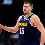 Denver Nuggets center Nikola Jokic (15) controls the ball in the fourth quarter against the Houston Rockets at Ball Arena.