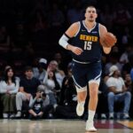 Denver Nuggets center Nikola Jokic (15) dribbles the basketball against the Miami Heat during the first quarter at Kaseya Center.
