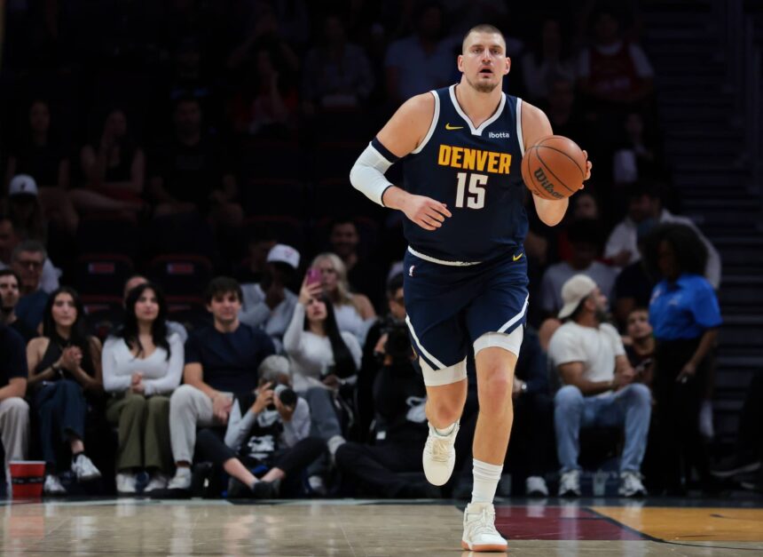 Denver Nuggets center Nikola Jokic (15) dribbles the basketball against the Miami Heat during the first quarter at Kaseya Center.