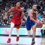 Dec 28, 2025; Toronto, Ontario, CAN; Golden State Warriors guard Stephen Curry (30) controls the ball as Toronto Raptors forward Scottie Barnes (4) tries to defend during the overtime at Scotiabank Arena. Mandatory Credit: Nick Turchiaro-Imagn Images