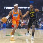 Oklahoma City Thunder guard Shai Gilgeous-Alexander (2) moves the ball down the court beside Golden State Warriors forward Jonathan Kuminga (1) during the first quarter at Paycom Center.