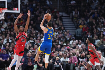 Dec 28, 2025; Toronto, Ontario, CAN; Golden State Warriors guard Stephen Curry (30) shoots the ball as Toronto Raptors guard Ochai Agbaji (30) tries to defend during the first quarter at Scotiabank Arena. Mandatory Credit: Nick Turchiaro-Imagn Images