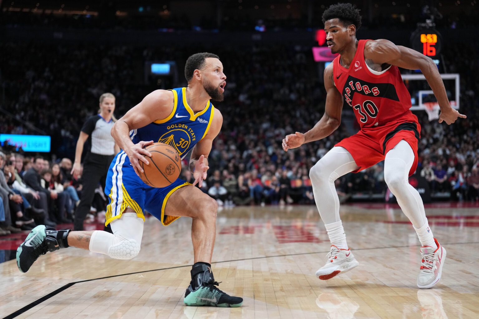 Dec 28, 2025; Toronto, Ontario, CAN; Golden State Warriors guard Stephen Curry (30) controls the ball as Toronto Raptors guard Ochai Agbaji (30) tries to defend during the third quarter at Scotiabank Arena. Mandatory Credit: Nick Turchiaro-Imagn Images