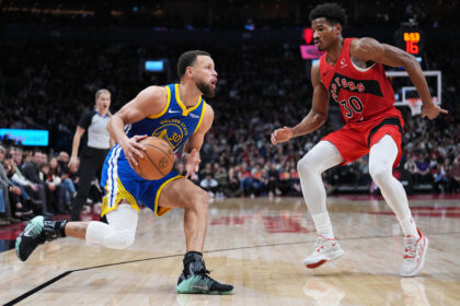 Dec 28, 2025; Toronto, Ontario, CAN; Golden State Warriors guard Stephen Curry (30) controls the ball as Toronto Raptors guard Ochai Agbaji (30) tries to defend during the third quarter at Scotiabank Arena. Mandatory Credit: Nick Turchiaro-Imagn Images