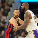 Golden State Warriors guard Stephen Curry (left) defends against Los Angeles Lakers forward LeBron James (right) during the fourth quarter at Chase Center.