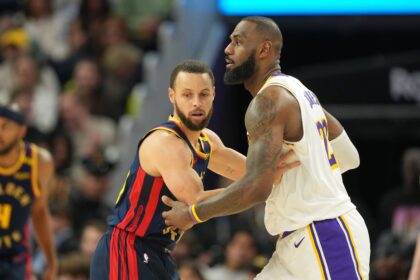 Golden State Warriors guard Stephen Curry (left) defends against Los Angeles Lakers forward LeBron James (right) during the fourth quarter at Chase Center.