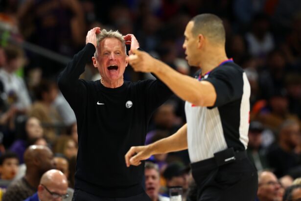 Dec 18, 2025; Phoenix, Arizona, USA; Golden State Warriors head coach Steve Kerr reacts against the Phoenix Suns in the second half at Mortgage Matchup Center. Mandatory Credit: Mark J. Rebilas-Imagn Images, top