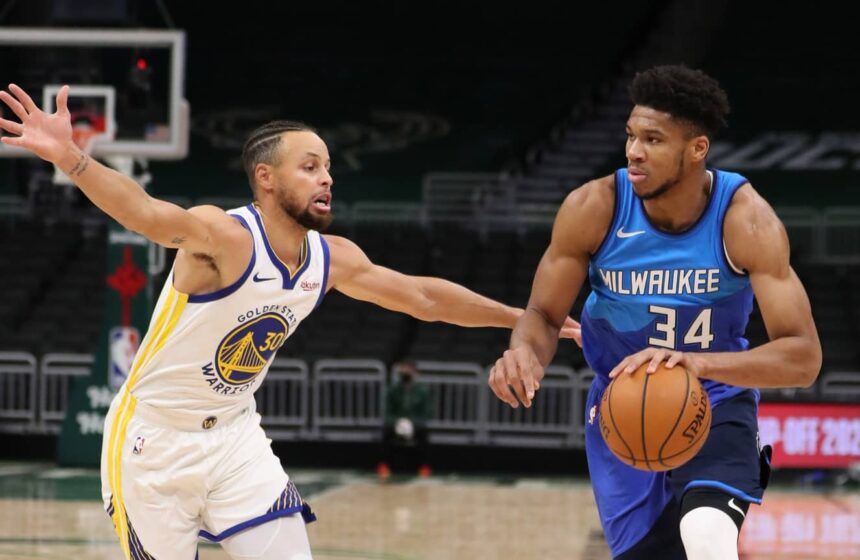 Dec 25, 2020; Milwaukee, WI, USA; Milwaukee Bucks forward Giannis Antetokounmpo (34) dribbles the ball against Golden State Warriors guard Stephen Curry (30) during a NBA game at the Bradley Center. Mandatory Credit: Nick Monroe/Handout Photo-Imagn Images