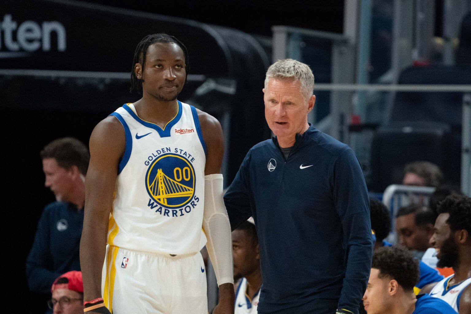 October 20, 2023; San Francisco, California, USA; Golden State Warriors head coach Steve Kerr (right) talks to forward Jonathan Kuminga (00) during the third quarter against the San Antonio Spurs at Chase Center. Mandatory Credit: Kyle Terada-Imagn Images