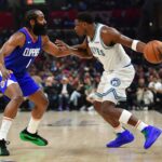 Mar 12, 2024; Los Angeles, California, USA; Minnesota Timberwolves guard Anthony Edwards (5) controls the ball against Los Angeles Clippers guard James Harden (1) during the first half at Crypto.com Arena. Mandatory Credit: Gary A. Vasquez-Imagn Images