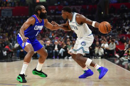 Mar 12, 2024; Los Angeles, California, USA; Minnesota Timberwolves guard Anthony Edwards (5) controls the ball against Los Angeles Clippers guard James Harden (1) during the first half at Crypto.com Arena. Mandatory Credit: Gary A. Vasquez-Imagn Images