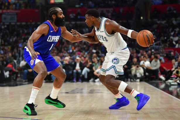 Mar 12, 2024; Los Angeles, California, USA; Minnesota Timberwolves guard Anthony Edwards (5) controls the ball against Los Angeles Clippers guard James Harden (1) during the first half at Crypto.com Arena. Mandatory Credit: Gary A. Vasquez-Imagn Images