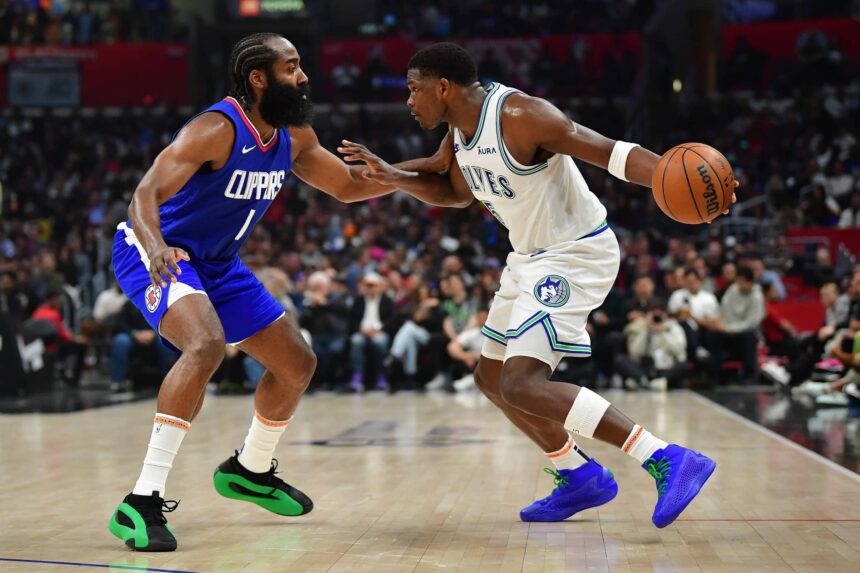 Mar 12, 2024; Los Angeles, California, USA; Minnesota Timberwolves guard Anthony Edwards (5) controls the ball against Los Angeles Clippers guard James Harden (1) during the first half at Crypto.com Arena. Mandatory Credit: Gary A. Vasquez-Imagn Images