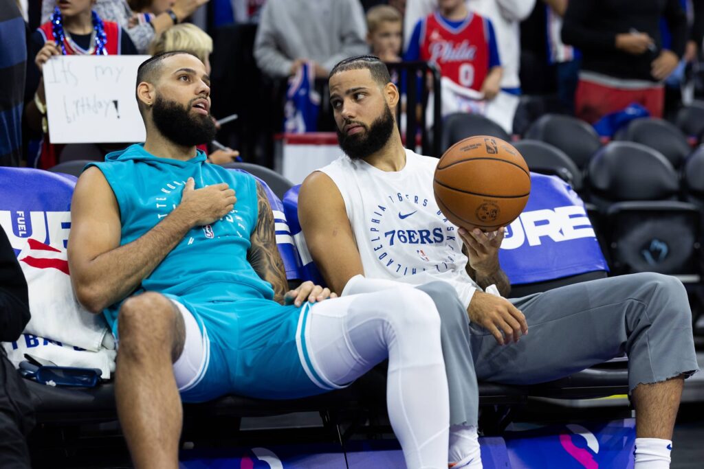Nov 10, 2024; Philadelphia, Pennsylvania, USA; Brothers Charlotte Hornets Cody Martin (L) and Philadelphia 76ers Caleb Martin (R) before a game at Wells Fargo Center. Mandatory Credit: Bill Streicher-Imagn Images