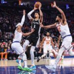 Dec 25, 2024; New York, New York, USA; San Antonio Spurs center Victor Wembanyama (1) looks to drive past New York Knicks guard Josh Hart (3) and center Karl-Anthony Towns (32) in the first quarter at Madison Square Garden. Mandatory Credit: Wendell Cruz-Imagn Images