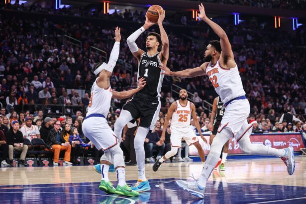 Dec 25, 2024; New York, New York, USA; San Antonio Spurs center Victor Wembanyama (1) looks to drive past New York Knicks guard Josh Hart (3) and center Karl-Anthony Towns (32) in the first quarter at Madison Square Garden. Mandatory Credit: Wendell Cruz-Imagn Images