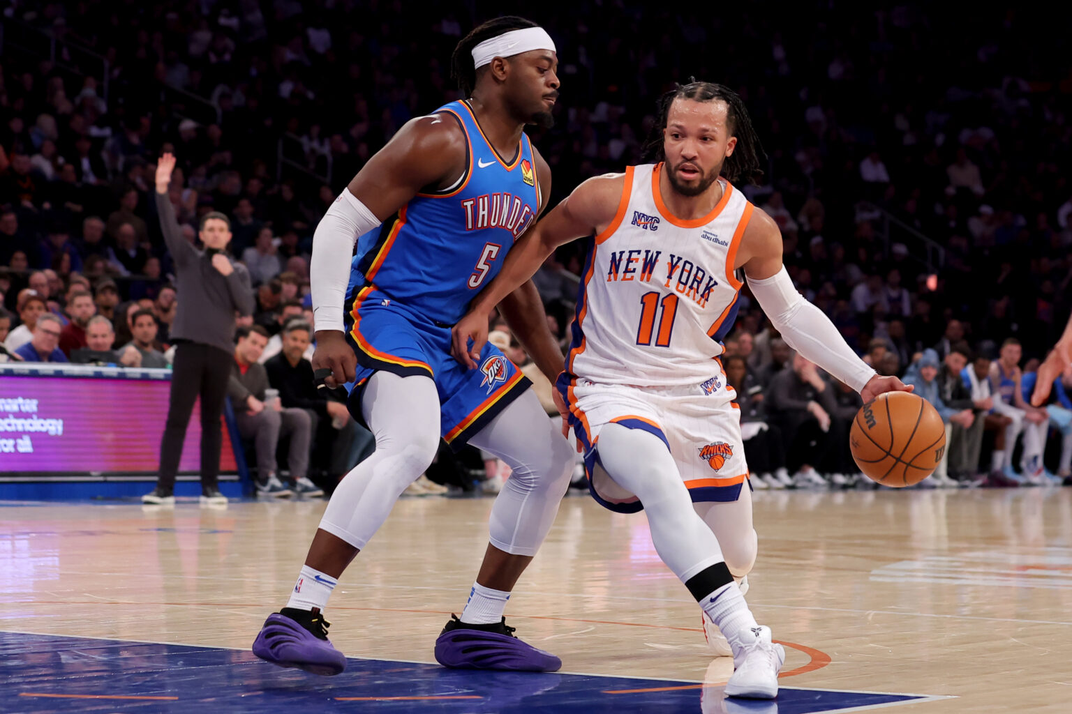 Jan 10, 2025; New York, New York, USA; New York Knicks guard Jalen Brunson (11) drives to the basket against Oklahoma City Thunder guard Luguentz Dort (5) during the third quarter at Madison Square Garden. Mandatory Credit: Brad Penner-Imagn Images