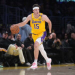 Jan 23, 2025; Los Angeles, California, USA; Los Angeles Lakers guard Austin Reaves (15) dribbles the ball against the Boston Celtics at the Crypto.com Arena. Mandatory Credit: Kirby Lee-Imagn Images