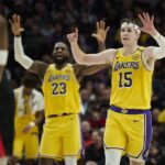 Feb 20, 2025; Portland, Oregon, USA; Los Angeles Lakers guard Austin Reaves (15) and forward LeBron James (23) signal to teammates during the second half against the Portland Trail Blazers at Moda Center. Mandatory Credit: Troy Wayrynen-Imagn Images