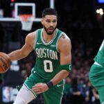 Mar 2, 2025; Boston, Massachusetts, USA; Boston Celtics forward Jayson Tatum (0) dribbles down the court during the second half against the Denver Nuggets at TD Garden. Mandatory Credit: Paul Rutherford-Imagn Images