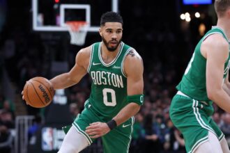 Mar 2, 2025; Boston, Massachusetts, USA; Boston Celtics forward Jayson Tatum (0) dribbles down the court during the second half against the Denver Nuggets at TD Garden. Mandatory Credit: Paul Rutherford-Imagn Images