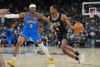 Mar 2, 2025; San Antonio, Texas, USA; San Antonio Spurs guard De'Aaron Fox (4) dribbles against Oklahoma City Thunder guard Shai Gilgeous-Alexander (2) in the first half at Frost Bank Center. Mandatory Credit: Daniel Dunn-Imagn Images