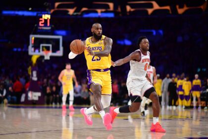 Mar 6, 2025; Los Angeles, California, USA; Los Angeles Lakers forward LeBron James (23) passes the ball ahead of New York Knicks forward OG Anunoby (8) during the second half at Crypto.com Arena. Mandatory Credit: Gary A. Vasquez-Imagn Images