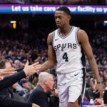 Mar 7, 2025; Sacramento, California, USA; San Antonio Spurs guard De'Aaron Fox (4) high fives team mates after coming out of the game during the fourth quarter at Golden 1 Center. Mandatory Credit: Ed Szczepanski-Imagn Images