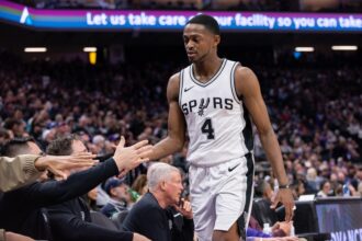 Mar 7, 2025; Sacramento, California, USA; San Antonio Spurs guard De'Aaron Fox (4) high fives team mates after coming out of the game during the fourth quarter at Golden 1 Center. Mandatory Credit: Ed Szczepanski-Imagn Images