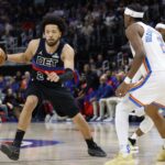 Mar 15, 2025; Detroit, Michigan, USA; Detroit Pistons guard Cade Cunningham (2) dribbles defended by Oklahoma City Thunder guard Shai Gilgeous-Alexander (2) in the first half at Little Caesars Arena. Mandatory Credit: Rick Osentoski-Imagn Images
