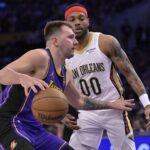 Apr 4, 2025; Los Angeles, California, USA; Los Angeles Lakers guard Luka Doncic (77) is defended by New Orleans Pelicans forward Bruce Brown (00) in the first half at Crypto.com Arena. Mandatory Credit: Jayne Kamin-Oncea-Imagn Images