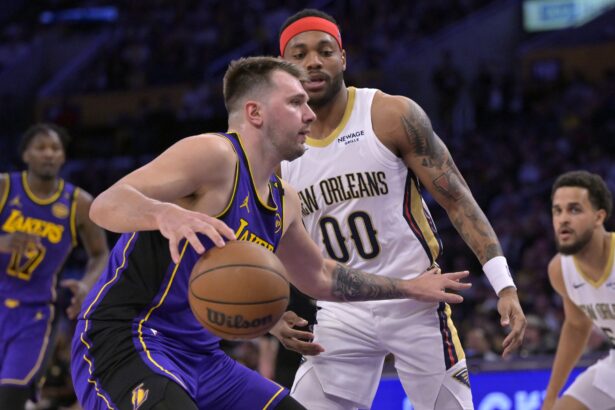 Apr 4, 2025; Los Angeles, California, USA; Los Angeles Lakers guard Luka Doncic (77) is defended by New Orleans Pelicans forward Bruce Brown (00) in the first half at Crypto.com Arena. Mandatory Credit: Jayne Kamin-Oncea-Imagn Images