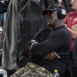 Apr 6, 2025; Darlington, South Carolina, USA; NASCAR Cup Series driver Tyler Reddick (45) team owner Michael Jordan watches his racer during the Goodyear 400 at Darlington Raceway. Mandatory Credit: Jim Dedmon-Imagn Images