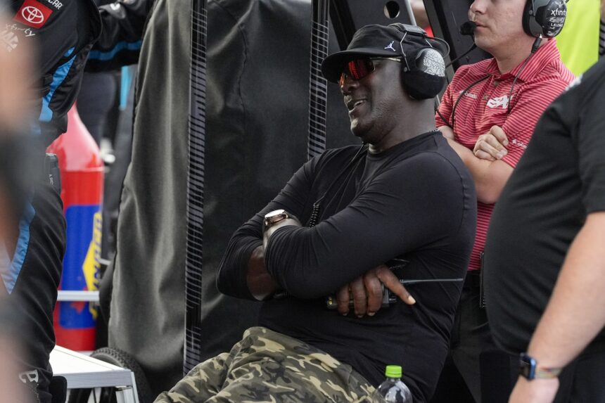 Apr 6, 2025; Darlington, South Carolina, USA; NASCAR Cup Series driver Tyler Reddick (45) team owner Michael Jordan watches his racer during the Goodyear 400 at Darlington Raceway. Mandatory Credit: Jim Dedmon-Imagn Images