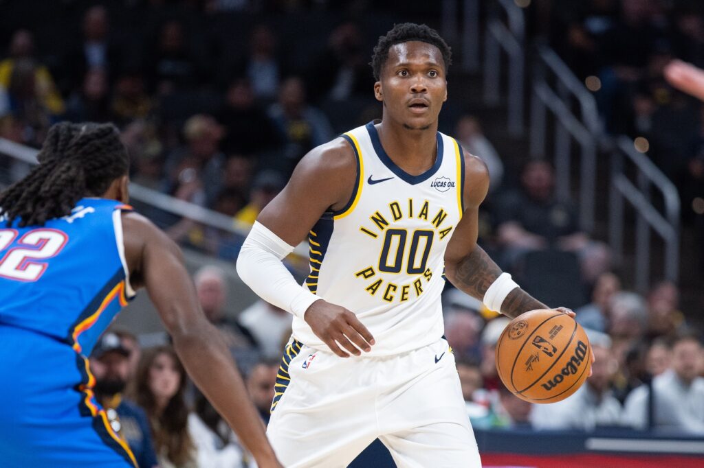 Oct 11, 2025; Indianapolis, Indiana, USA; Indiana Pacers guard/forward Bennedict Mathurin (00) dribbles the ball while Oklahoma City Thunder guard Cason Wallace (22) defends in the first half at Gainbridge Fieldhouse. Mandatory Credit: Trevor Ruszkowski-Imagn Images