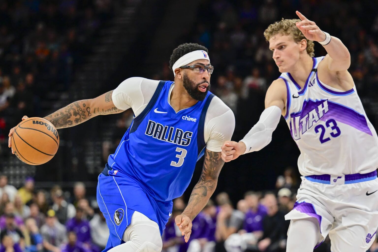 Oct 13, 2025; Salt Lake City, Utah, USA; Dallas Mavericks forward/center Anthony Davis (3) drives to the basket into Utah Jazz forward/center Lauri Markkanen (23) during the second quarter at Delta Center. Mandatory Credit: Peter Creveling-Imagn Images